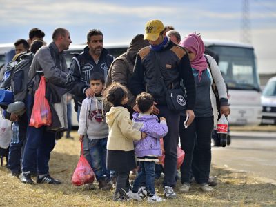 October 5, 2015; Tovarnik in Croatia. Croatian police assist refugees get into train which will go to Hungary.